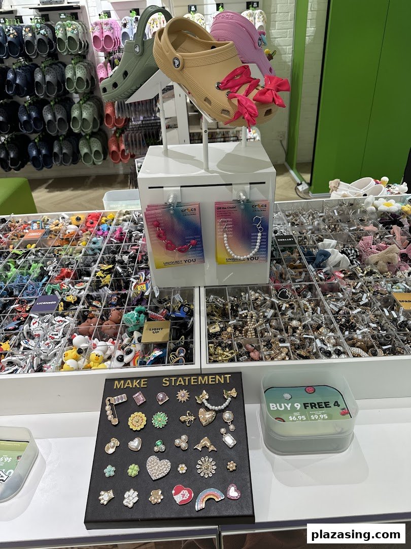 An interior shot of a Crocs store featuring shoes, Jibbitz charms, and various accessories on display.