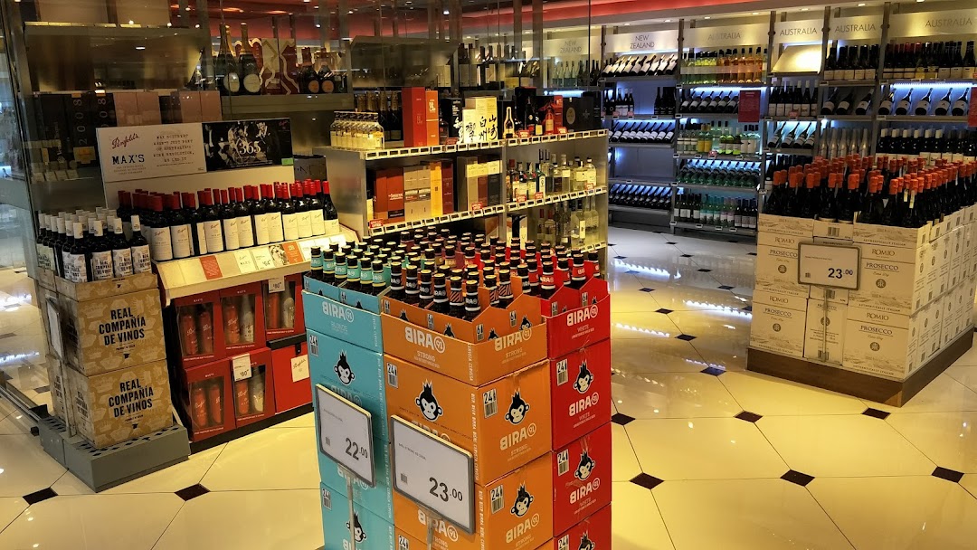 A well-stocked aisle at CS Fresh featuring a wide selection of wines, beers, and spirits.