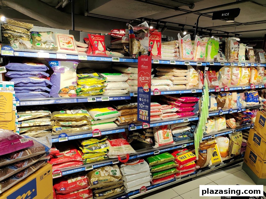 A well-stocked supermarket aisle displaying various types of rice and grains on multiple shelves.