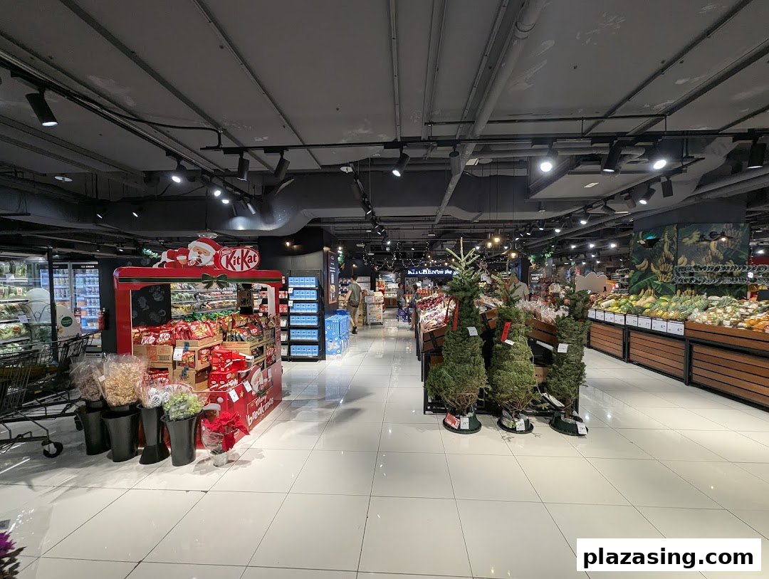 An interior view of CS Fresh supermarket, featuring fresh produce, a festive Kit Kat display, and Christmas trees.
