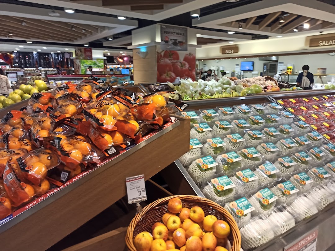 A vibrant fresh produce section at CS Fresh, featuring oranges, apples, and other fruits and vegetables.