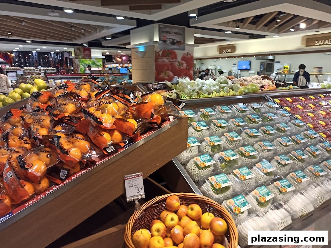 A vibrant fresh produce section at CS Fresh, featuring oranges, apples, and other fruits and vegetables.