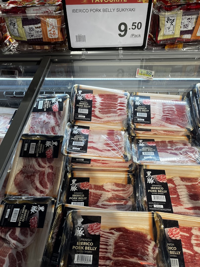 A refrigerated display showcasing various cuts of premium packaged Iberico pork, including belly and collar, for sukiyaki and shabu shabu.