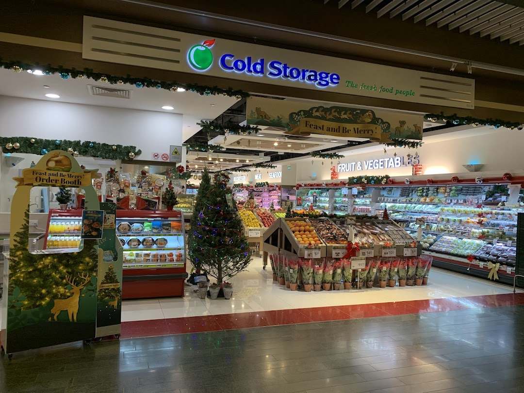 Interior view of Cold Storage supermarket, featuring fresh produce, festive decorations, and a Christmas order booth.