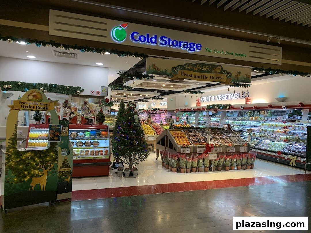 Interior view of Cold Storage supermarket, featuring fresh produce, festive decorations, and a Christmas order booth.