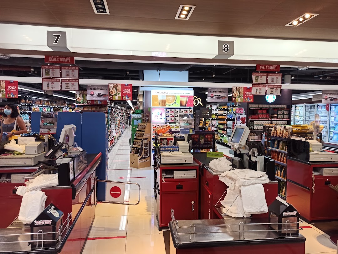 View of CS Fresh supermarket checkout counters and aisles, showcasing daily deals and fresh produce sections.