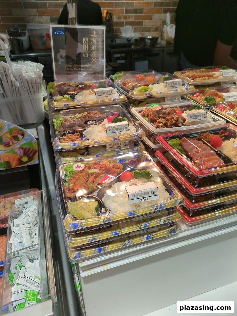 A vibrant display of various pre-packaged Japanese bento boxes and ready-to-eat meals at CS Fresh.