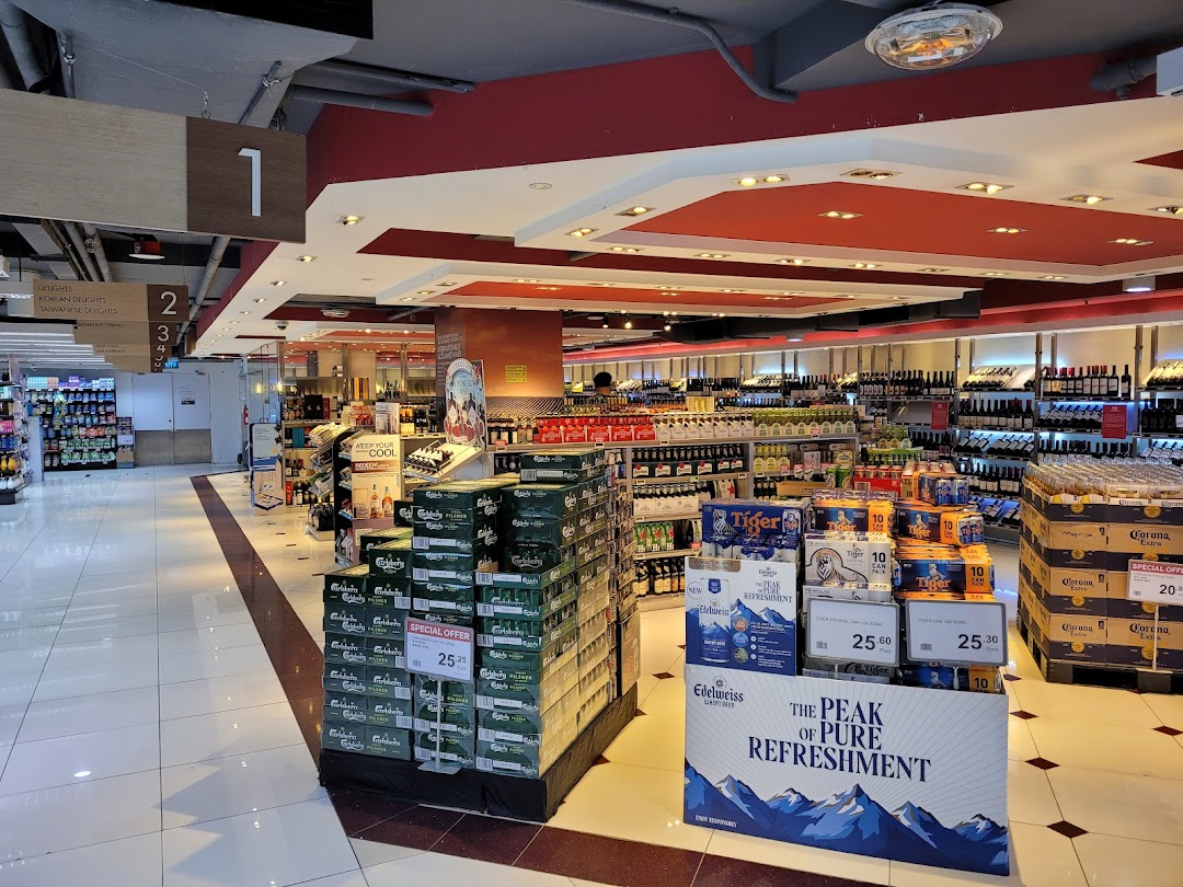 An aisle inside CS Fresh supermarket, showcasing a wide array of beverages, including beers and wines.