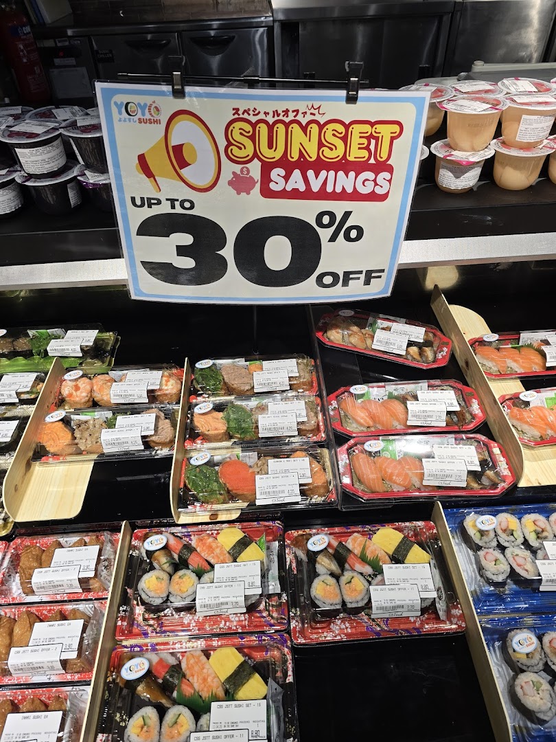 A display of pre-packaged sushi sets from YoYo Sushi with a 'Sunset Savings' promotion sign at CS Fresh.