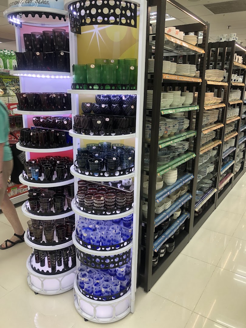 An interior shot of Daiso Threeppy, showcasing a vibrant display of glassware and shelves filled with various ceramic dishes.