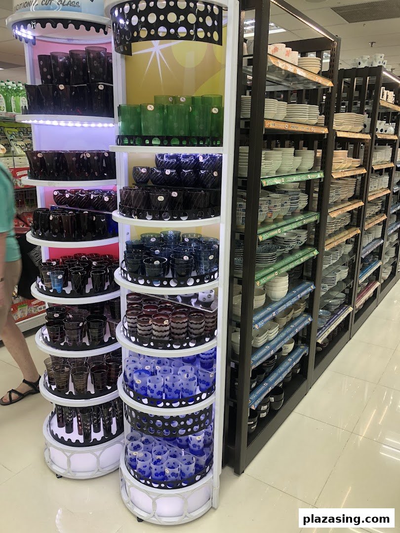 An interior shot of Daiso Threeppy, showcasing a vibrant display of glassware and shelves filled with various ceramic dishes.