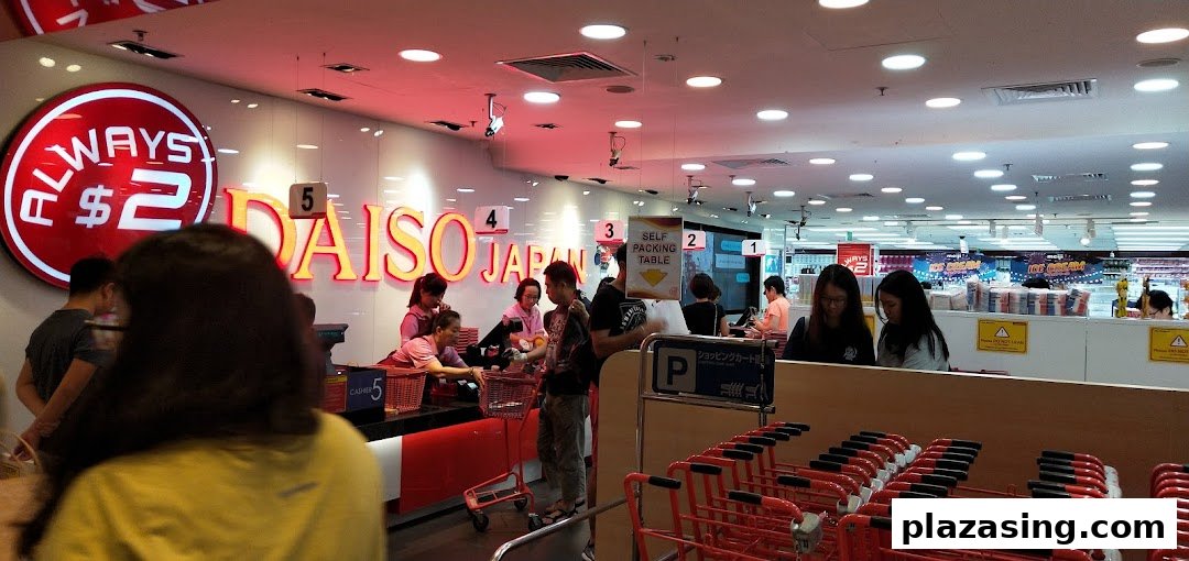 Customers and staff at the checkout counters inside a bustling Daiso Japan store.