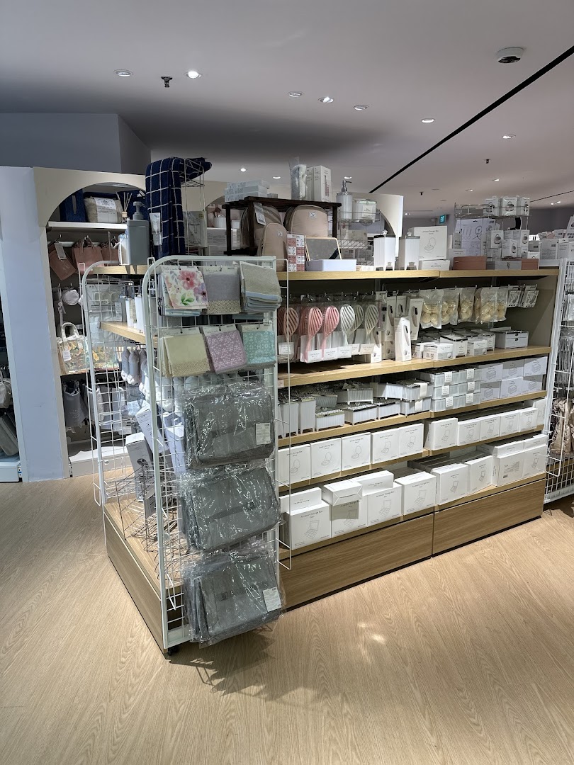 Interior view of DAISO THREEPPY, showcasing shelves filled with diverse household and lifestyle products.