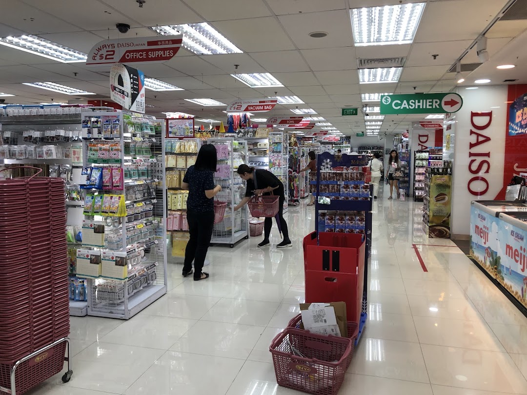 Customers browse diverse products in the brightly lit aisles of a DAISO store, featuring office supplies and household items.