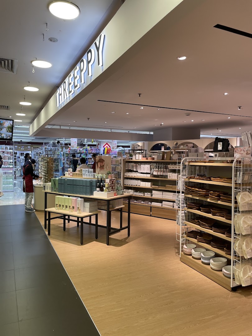 An interior view of DAISO THREEPPY, showcasing homeware, lifestyle products, and organized displays.