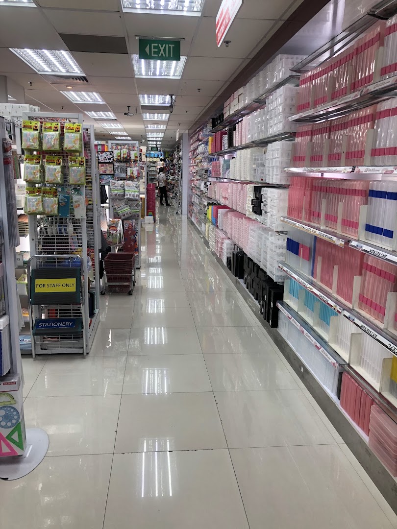 A brightly lit interior aisle of Daiso, featuring shelves stocked with diverse products.