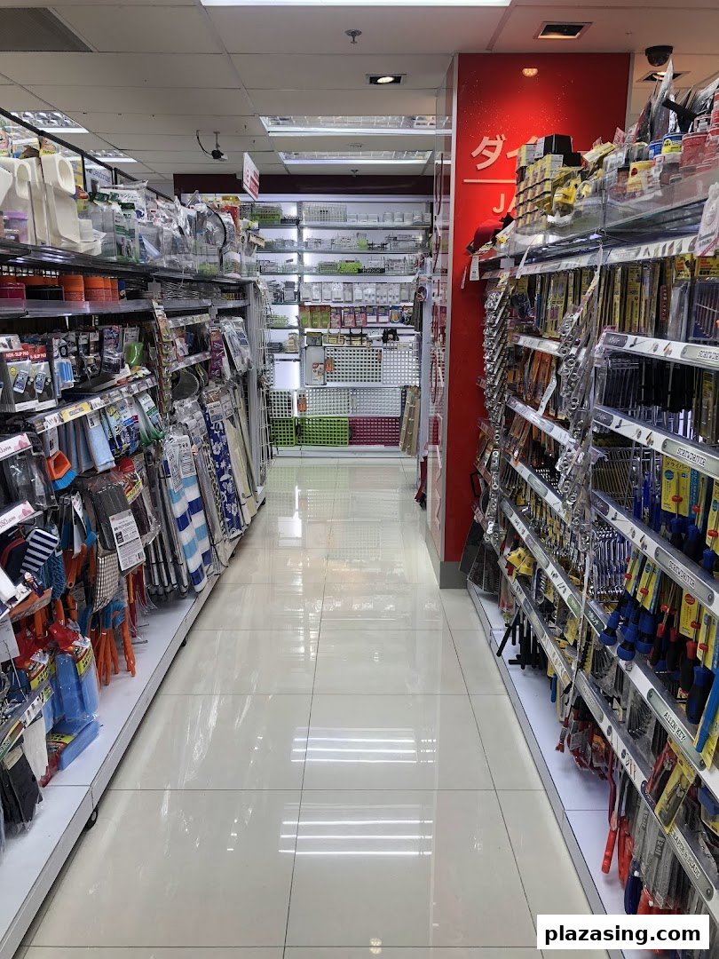An interior view of a DAISO store aisle, showcasing shelves filled with diverse household and lifestyle products.