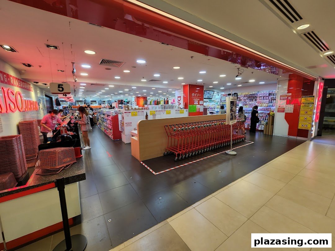 The bright red and white entrance of Daiso Japan, showcasing shopping carts, checkout, and product aisles.