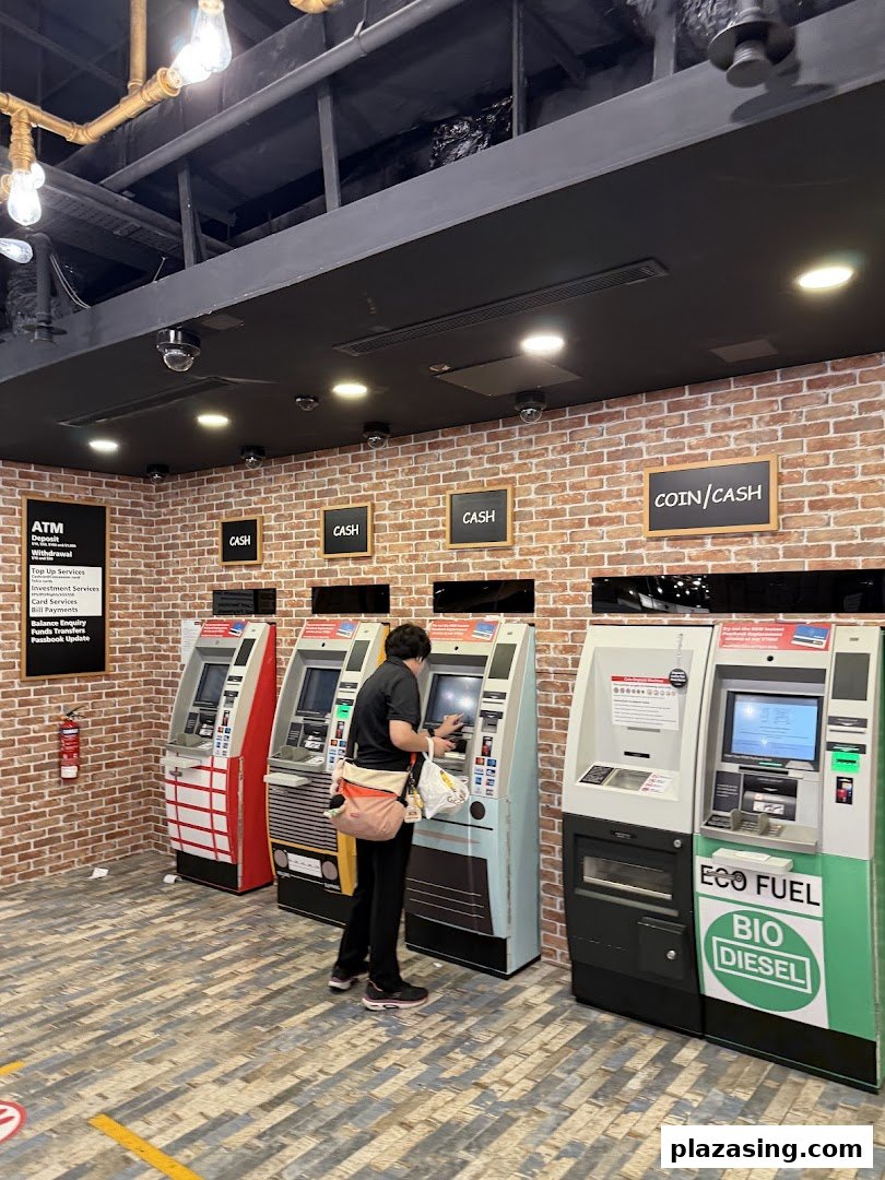 A customer uses one of several DBS ATMs in a brick-walled banking area at Plaza Singapura.