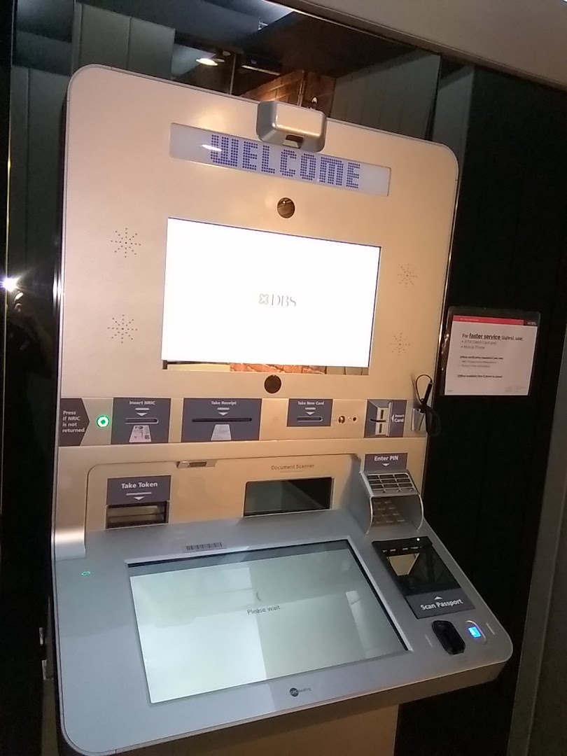 A DBS self-service kiosk displaying 'WELCOME' and offering various banking functions.