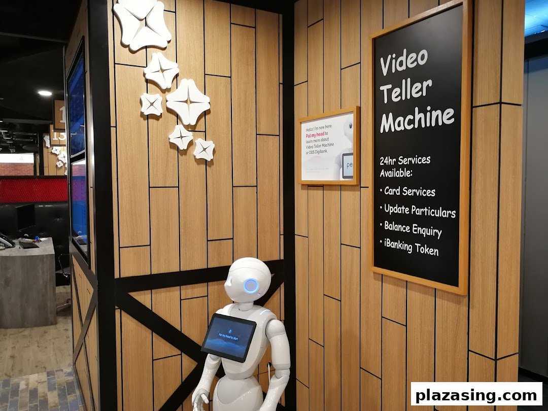 An interior view of DBS Plaza Singapura featuring a robot assistant and a sign for 24hr Video Teller Machine services.