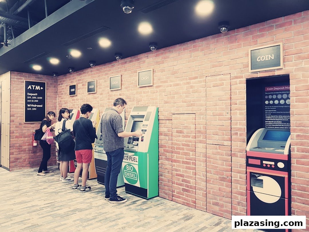 Customers use ATMs and a coin deposit machine at a modern DBS bank branch.