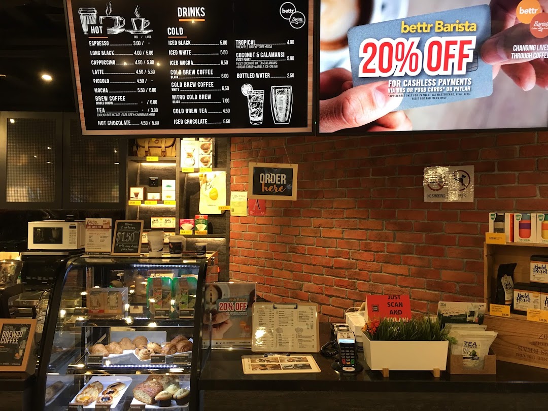 Interior view of the Bettr Barista cafe area within DBS Plaza Singapura Branch, featuring a menu and pastry display.