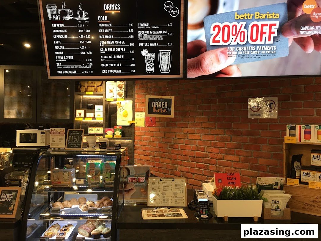 Interior view of the Bettr Barista cafe area within DBS Plaza Singapura Branch, featuring a menu and pastry display.