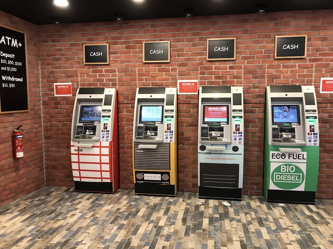 Four DBS ATMs with unique designs against a brick wall, offering deposit and withdrawal services.