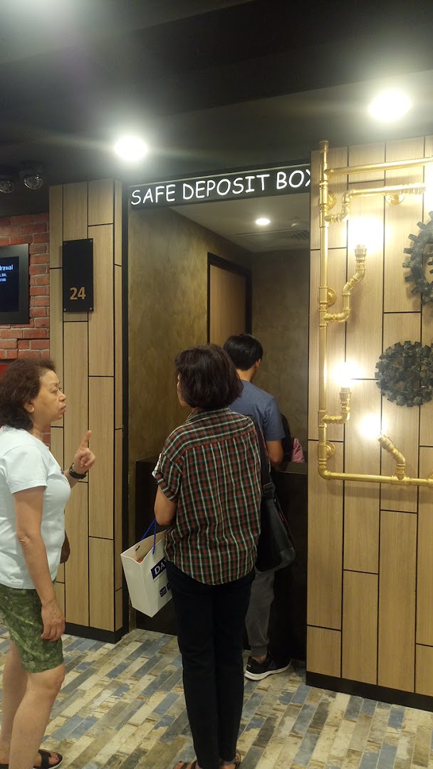 Customers accessing safe deposit boxes at DBS Plaza Singapura, featuring modern interior design.