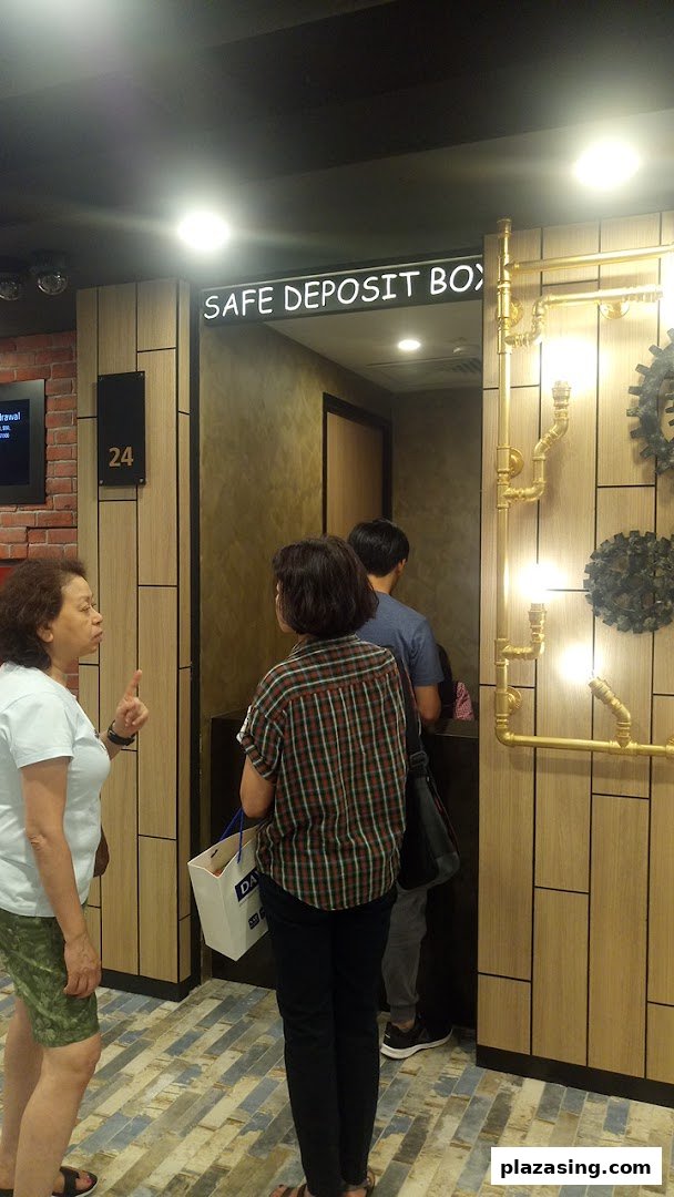 Customers accessing safe deposit boxes at DBS Plaza Singapura, featuring modern interior design.
