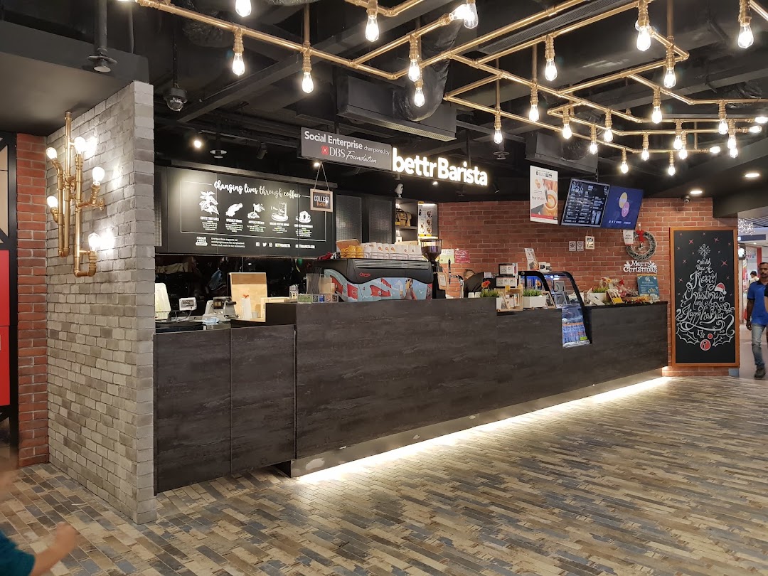 An inviting interior view of Bettr Barista coffee shop, featuring a counter, coffee machine, and festive decor.