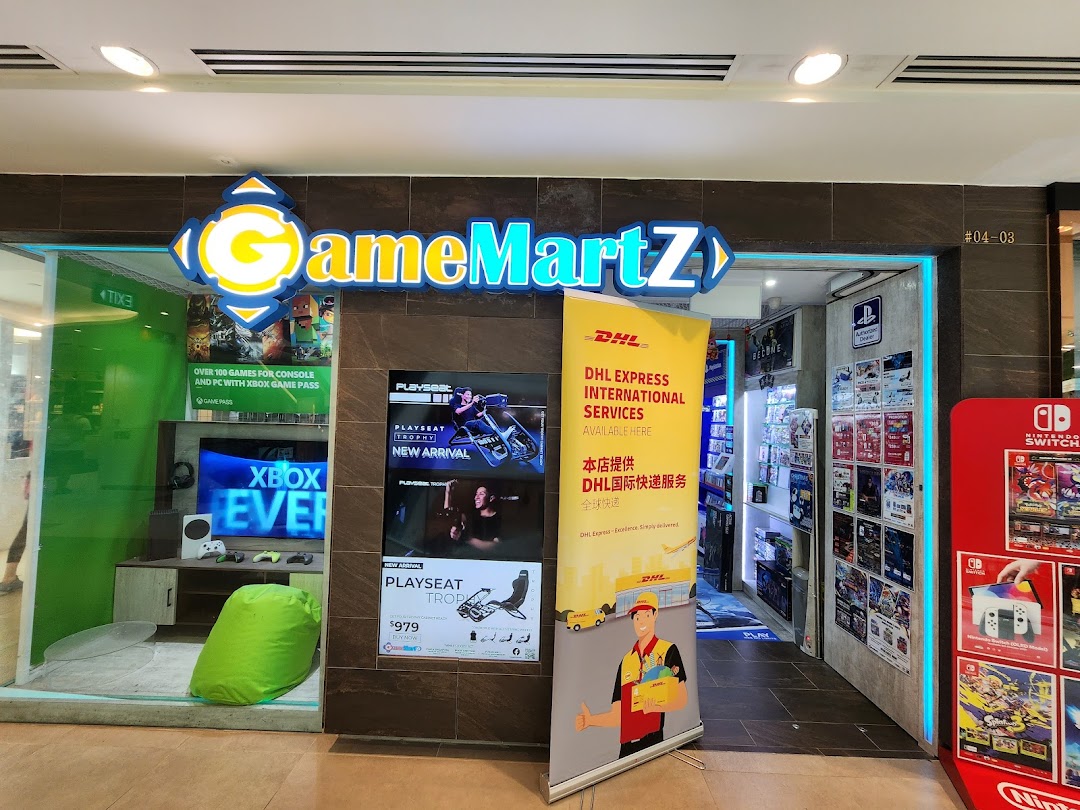 The storefront of GameMartz, a gaming shop, featuring gaming displays and an integrated DHL Express Service Point.