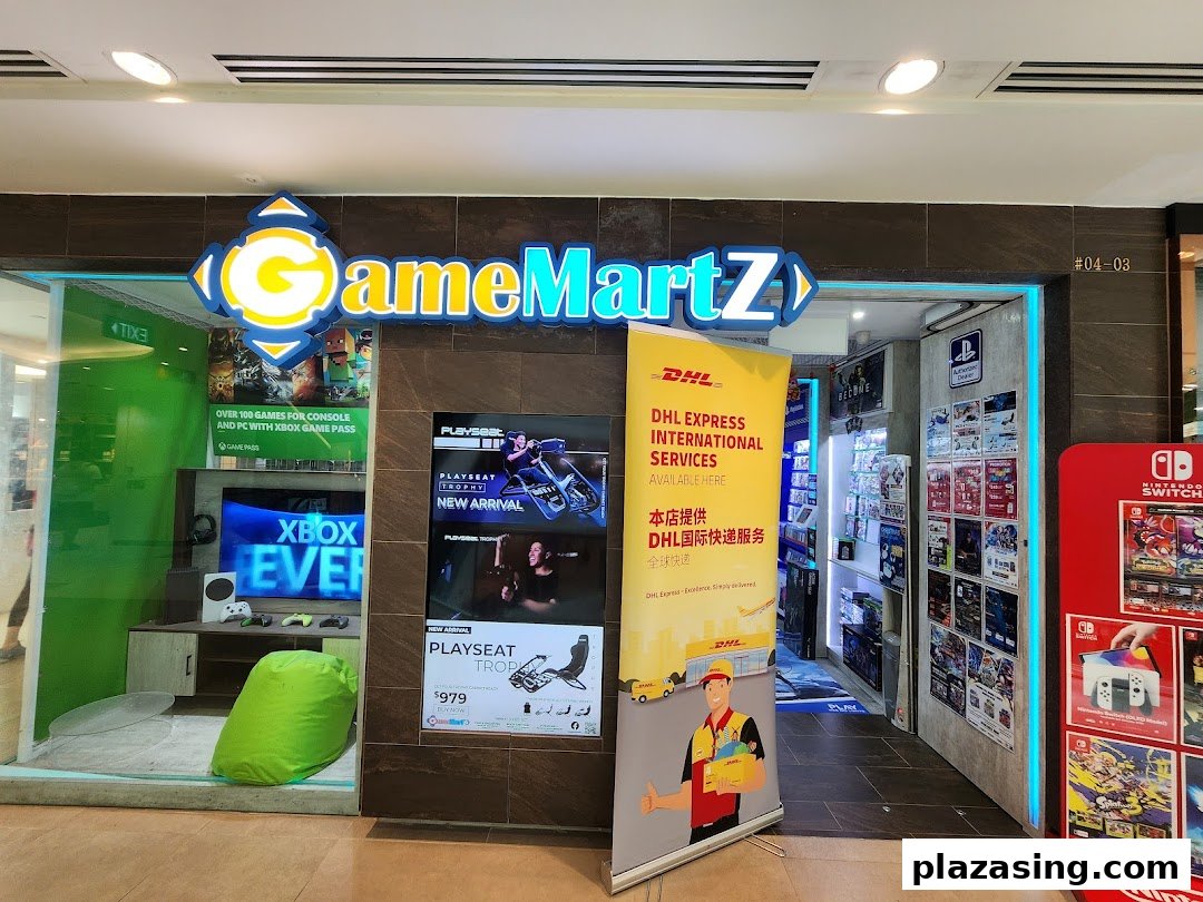 The storefront of GameMartz, a gaming shop, featuring gaming displays and an integrated DHL Express Service Point.