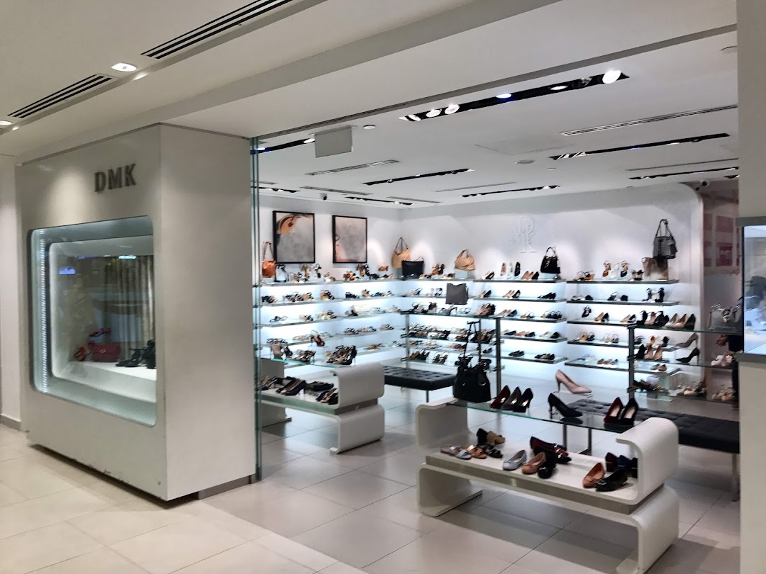 Interior view of DMK shoe and bag store, showcasing a wide array of footwear and accessories on display.