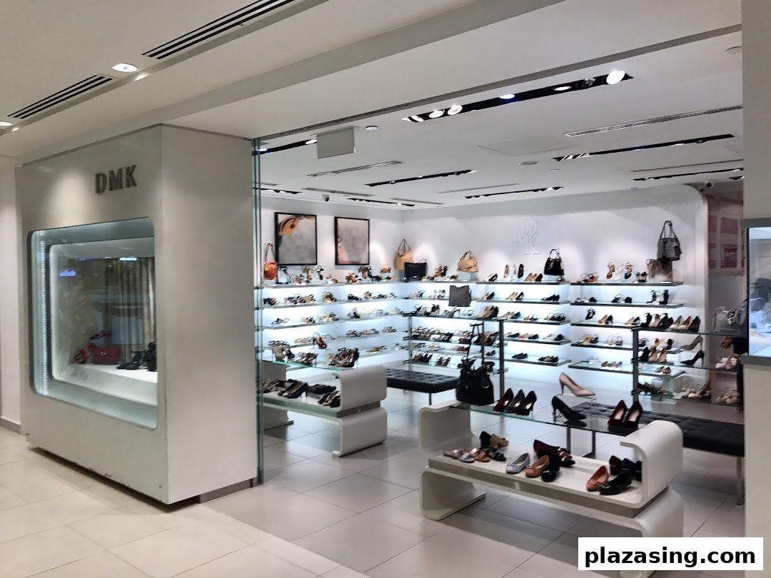 Interior view of DMK shoe and bag store, showcasing a wide array of footwear and accessories on display.