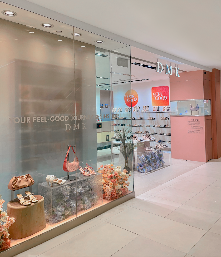 The inviting storefront of DMK, a footwear and accessories shop, showcasing stylish shoes and bags.
