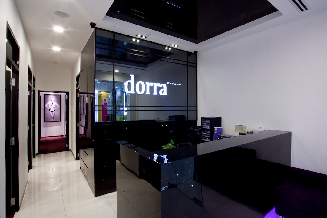 Modern interior of Dorra Slimming featuring a sleek reception desk and a hallway leading to treatment rooms.