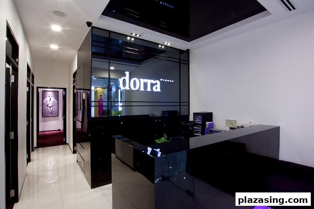 Modern interior of Dorra Slimming featuring a sleek reception desk and a hallway leading to treatment rooms.