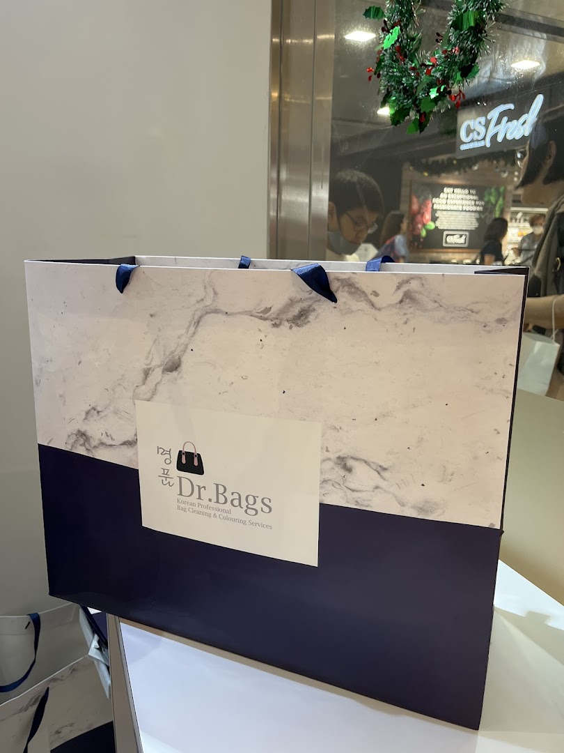 A Dr. Bags shopping bag featuring its logo and Korean professional bag cleaning services.