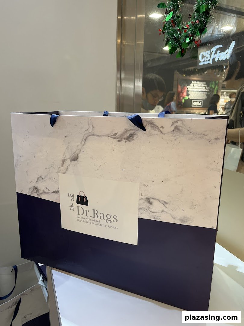 A Dr. Bags shopping bag featuring its logo and Korean professional bag cleaning services.