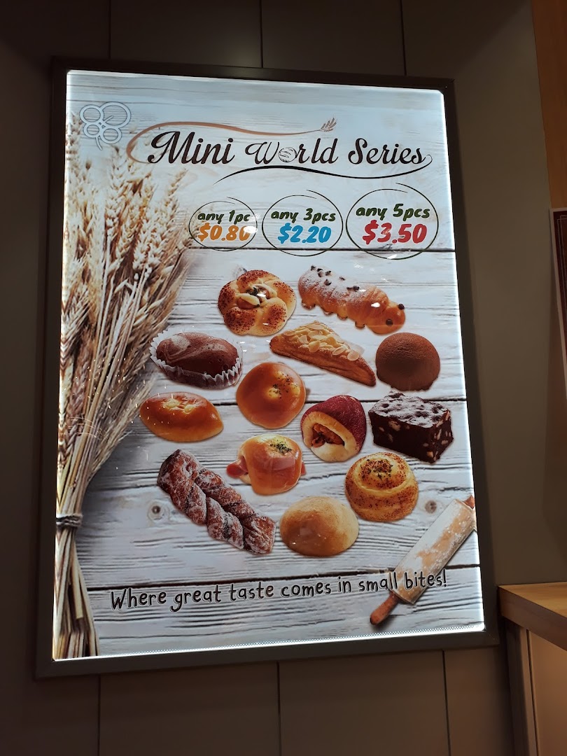 A bright display board showcasing Epi Dor's 'Mini World Series' pastries with pricing.