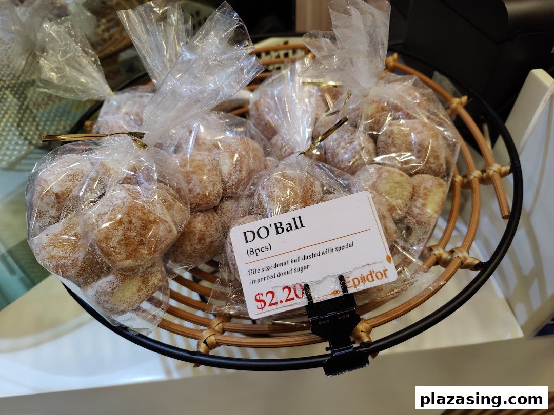 Close-up of packaged 'Do'Ball' donut balls from Epi Dor, displayed in a basket with a price tag.