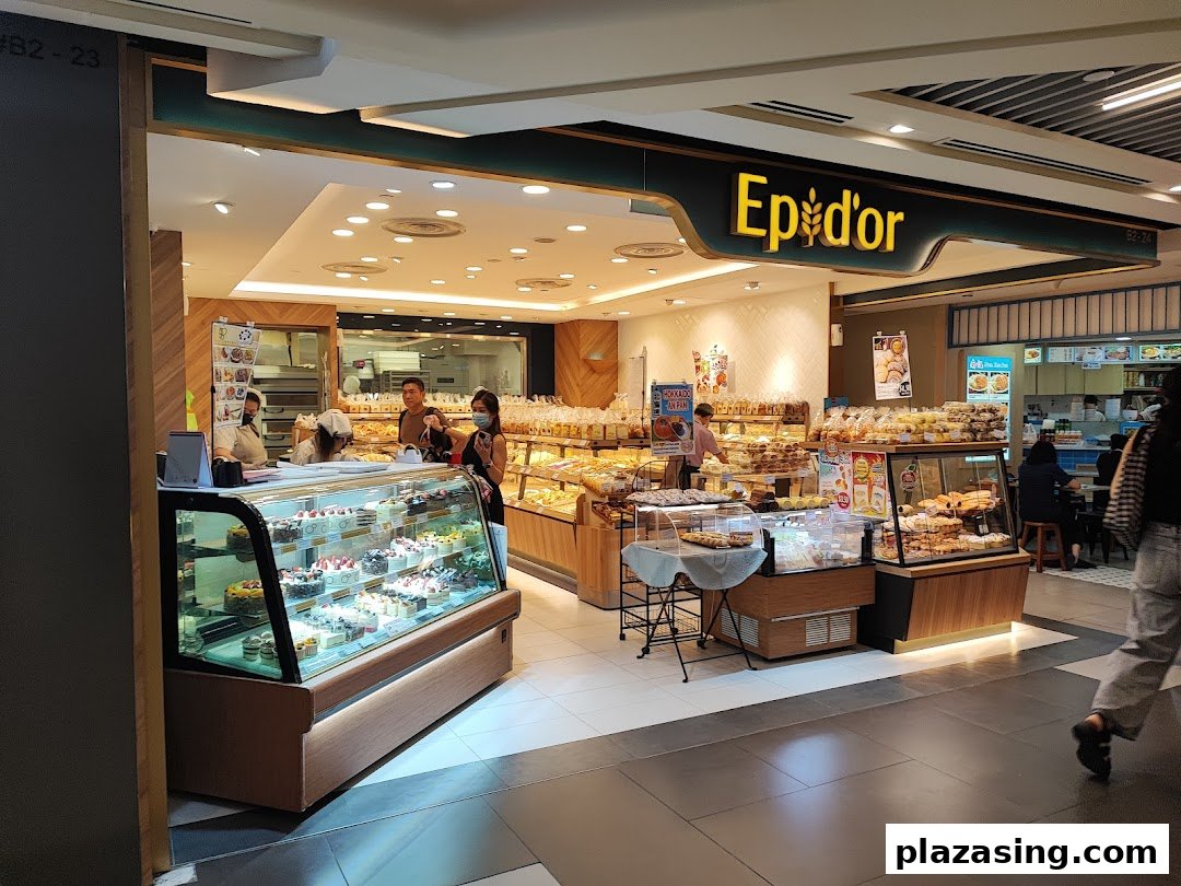 Epi Dor bakery entrance showcasing a wide array of freshly baked bread, pastries, and cakes.