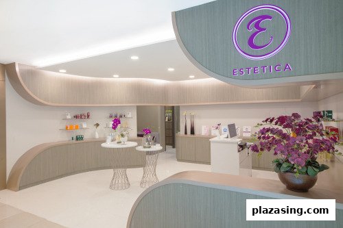 A clean and modern interior view of Estetica Beauty, featuring product displays and a reception area.
