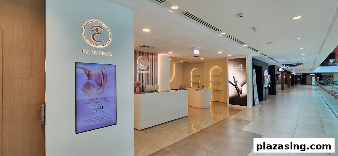 The bright, modern entrance of Estetica Beauty, a beauty and wellness salon, with promotional displays.