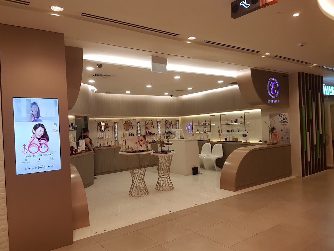 The inviting entrance of Estetica Beauty, a skincare and beauty salon, featuring a digital display.