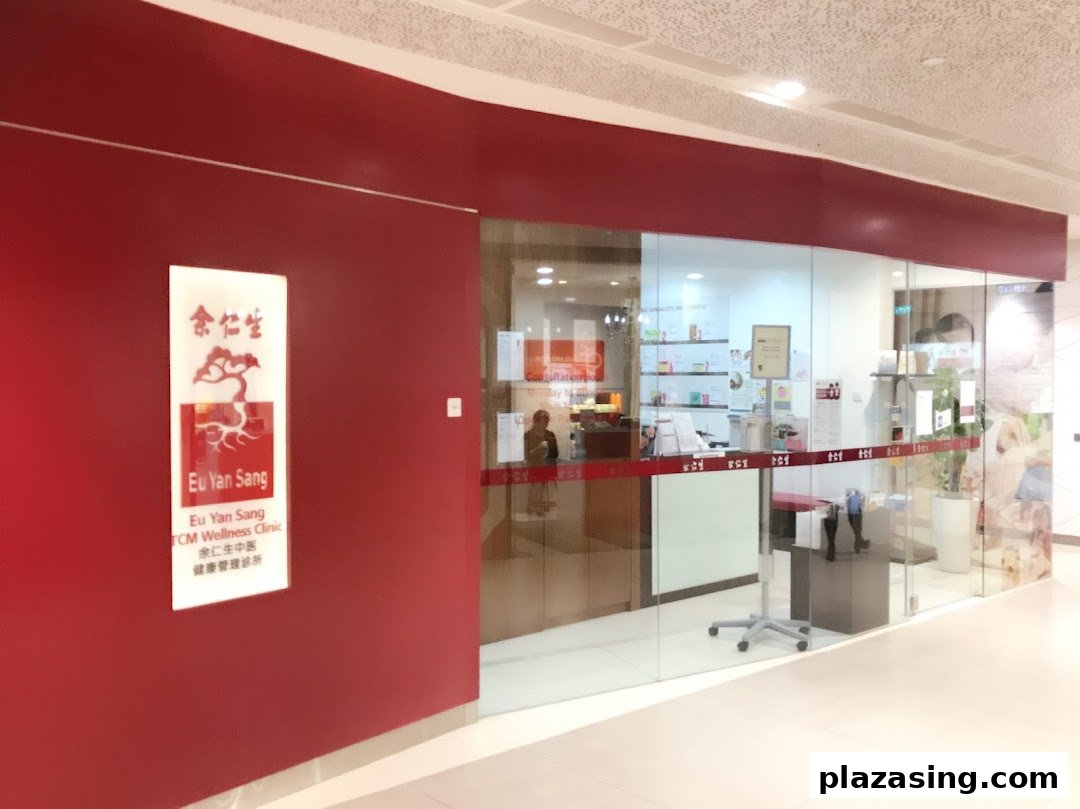 The red facade and glass entrance of Eu Yan Sang TCM Wellness Clinic, featuring its prominent signage.