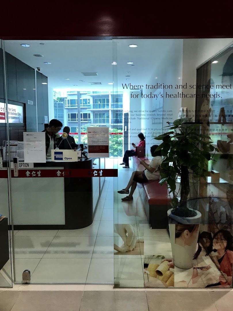 View through the glass entrance of Eu Yan Sang TCM Clinic, showing the reception and waiting area.