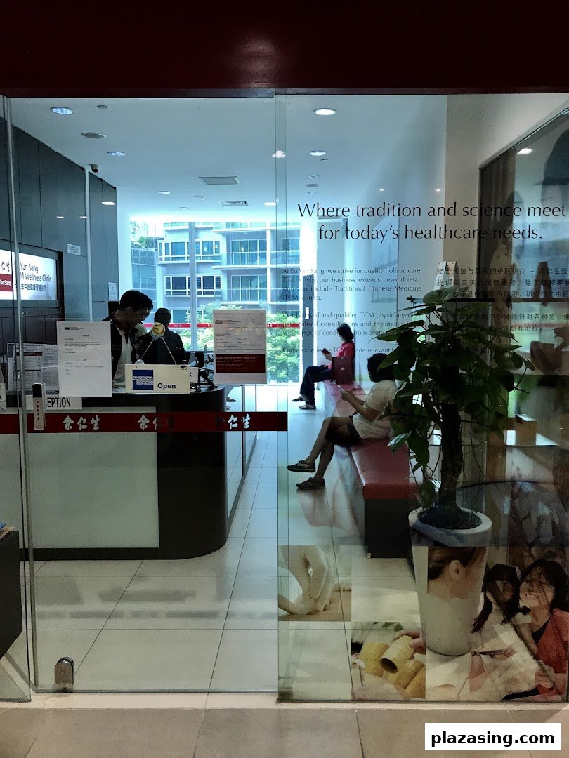 View through the glass entrance of Eu Yan Sang TCM Clinic, showing the reception and waiting area.
